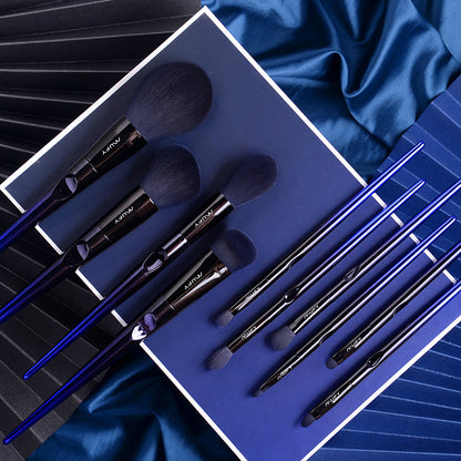 10-piece blue nylon bristles makeup brush set with sleek blue handles on dark blue and black textured background