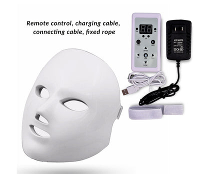 White LED facial beauty mask with remote control, charging cables, and fixed strap for skin rejuvenation