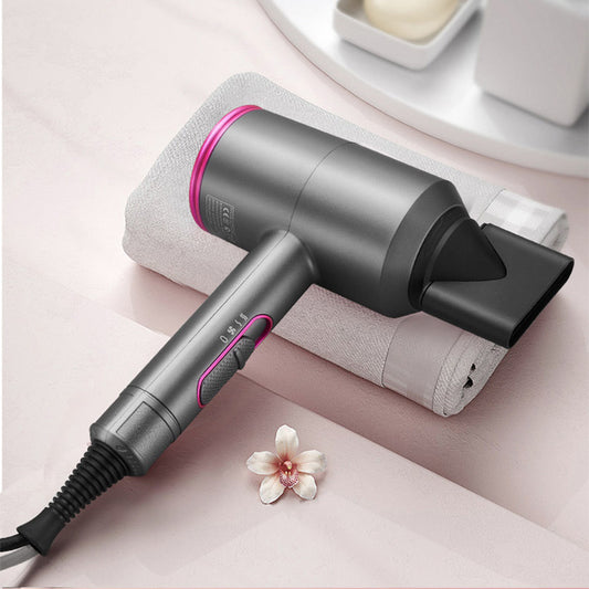 Gray and pink ionic hair dryer with concentrator nozzle on white towel with flower on pink surface