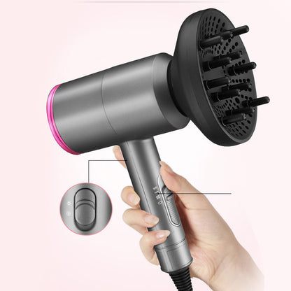 Hand holding a gray ionic hair dryer with a black diffuser attachment and visible control switches