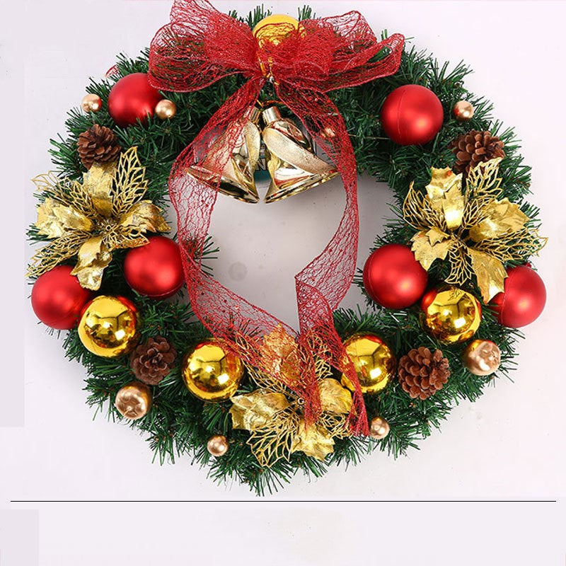 Christmas wreath decorated with red and gold baubles, pine cones, gold leaves, red bow, and gold bells