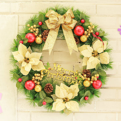 Christmas wreath with gold bow, red and gold ornaments, pine cones, and Merry Christmas sign