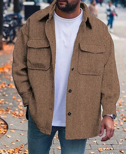 men's brown herringbone polo collar coat with long sleeves and flap pockets worn over white t-shirt in autumn street