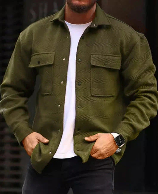 Man wearing olive green long-sleeve polo collar jacket with front pockets over white tee and black pants
