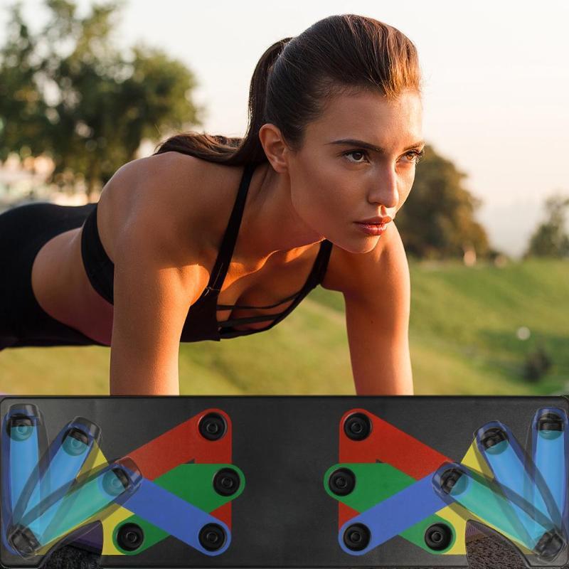 Woman doing push-ups outdoors using colorful folding push-up board for home gym workout