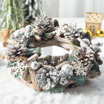 Silver Christmas wreath with pine cones, wooden snowflakes, berries, and green leaves on white fur