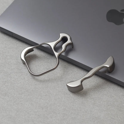 Zinc alloy metal phone holder and stand attached to the edge of a gray Apple MacBook laptop