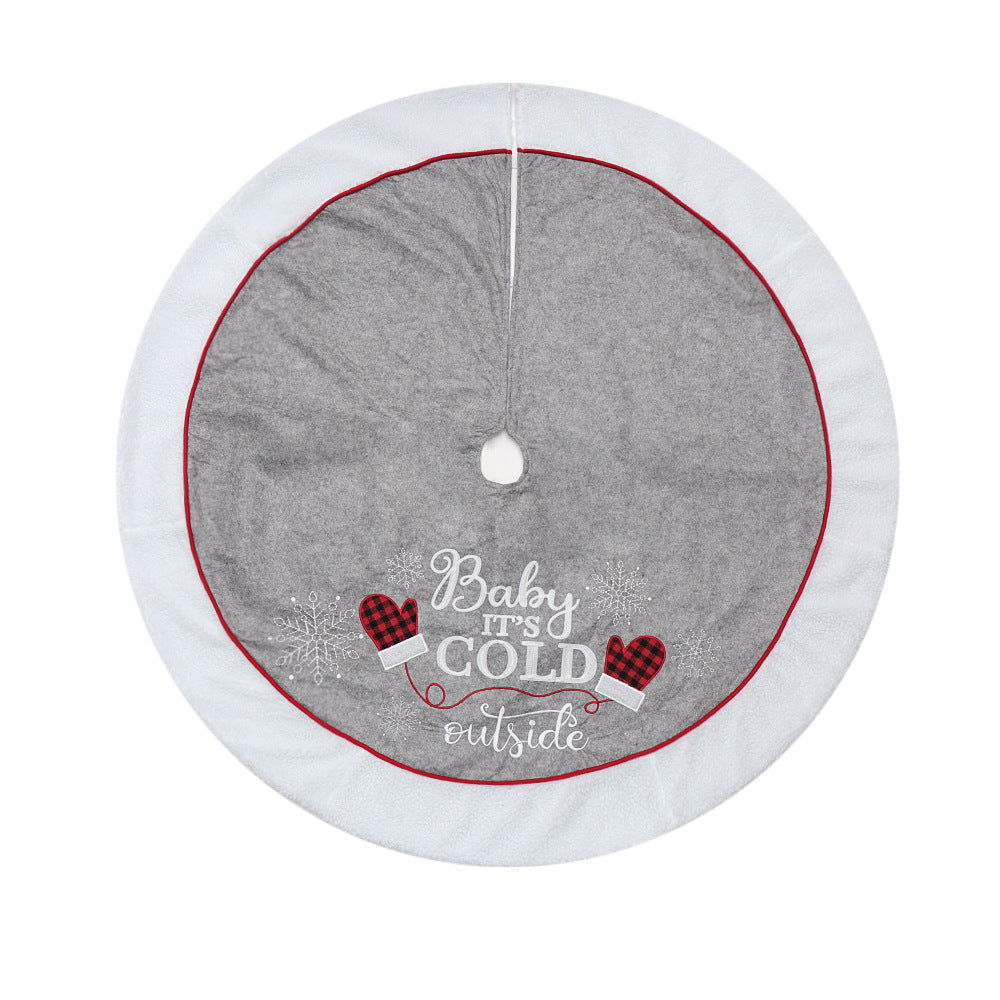Round gray and white Christmas tree skirt with red trim and festive mittens design saying Baby it's cold outside