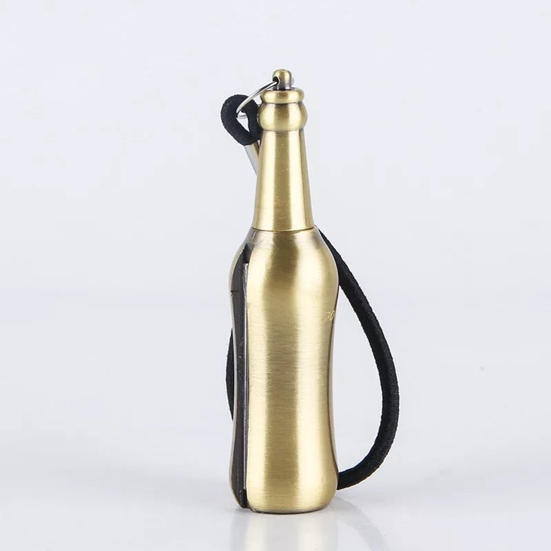 Gold metal bottle-shaped keychain lighter with flint, kerosene fire starter, and black strap