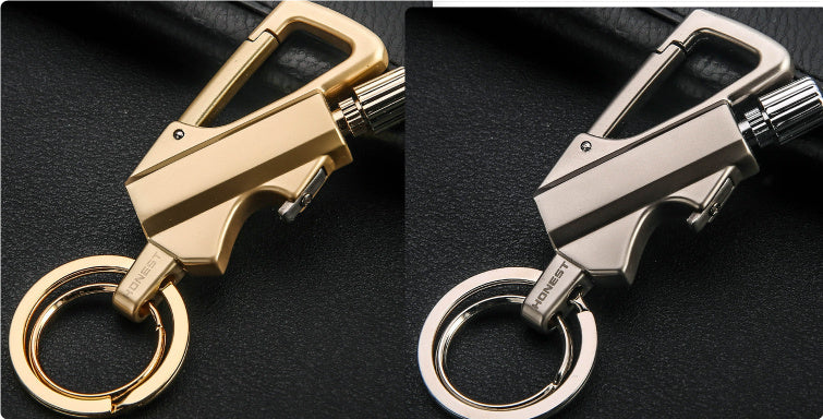 Gold and silver metal carabiner keychain lighters with flint wheel and key rings on black surface