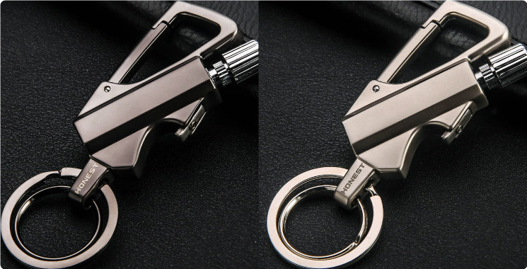 close-up of gold metal keychain lighter with bottle opener and flint striker on black leather surface