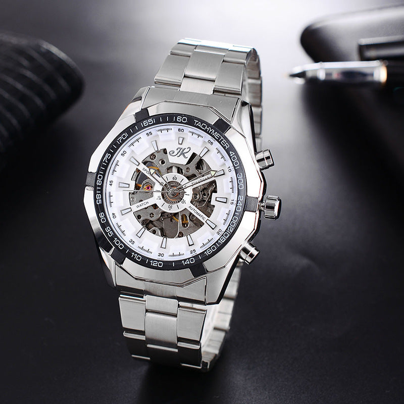 silver men's mechanical watch with skeleton dial, tachymeter bezel, and stainless steel band on black surface