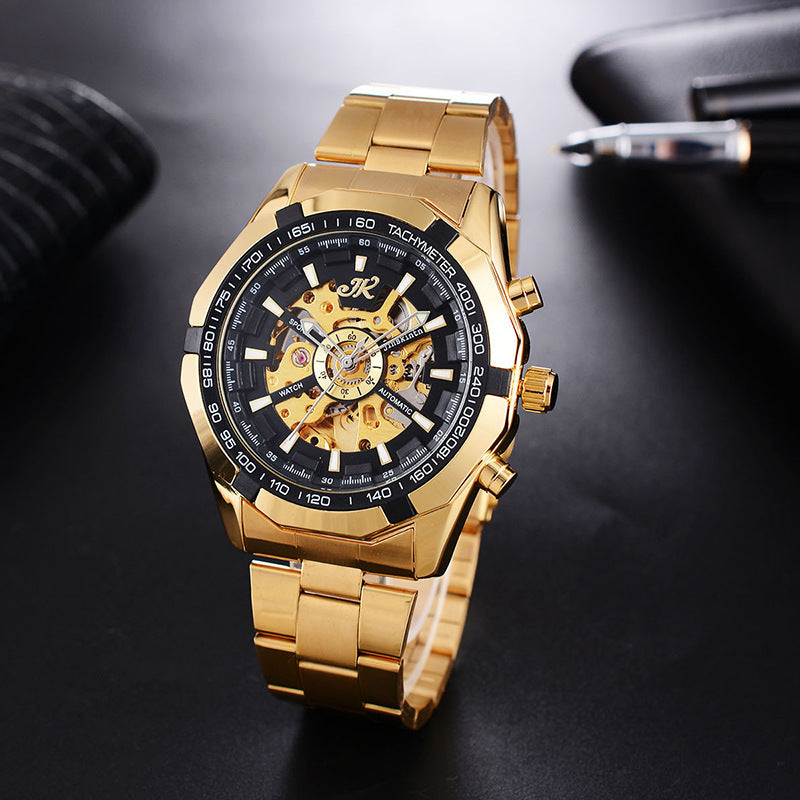 Gold men's mechanical wristwatch with black tachymeter dial and steel band on black surface
