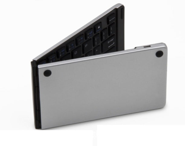 Foldable silver Bluetooth keyboard with black keys, ultra-thin portable wireless design