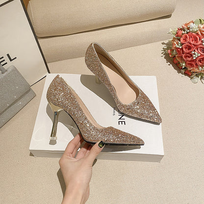 Gold glitter pointed toe high heel wedding shoes with shiny metallic heels on white box