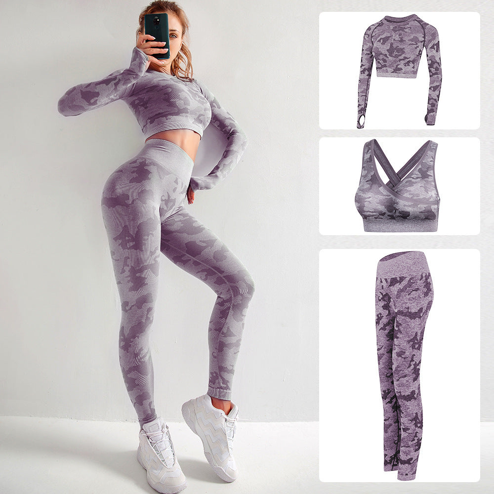 Woman wearing purple camo seamless workout set with long sleeve crop top and leggings, white sneakers
