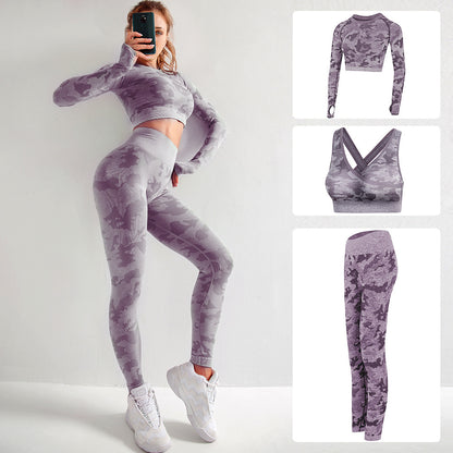 Woman wearing purple camo seamless workout set with long sleeve crop top and leggings, white sneakers