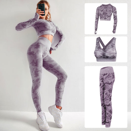 Woman wearing purple camo seamless workout set with long sleeve crop top and leggings, white sneakers