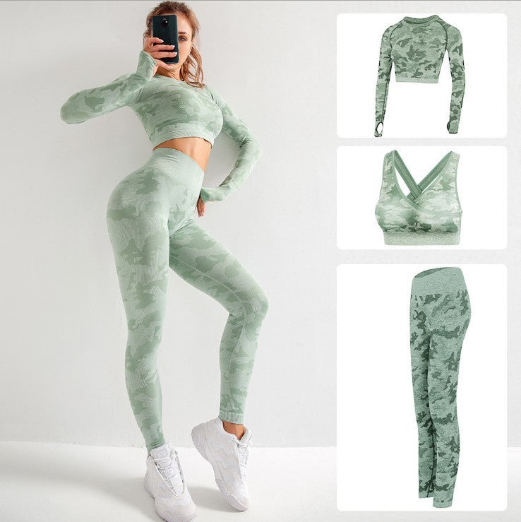 Woman wearing green camo seamless 3-piece yoga set with leggings, long sleeve crop top, and sports bra