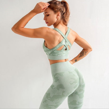 Woman wearing green camo seamless yoga set with crisscross back sports bra and high-waist leggings