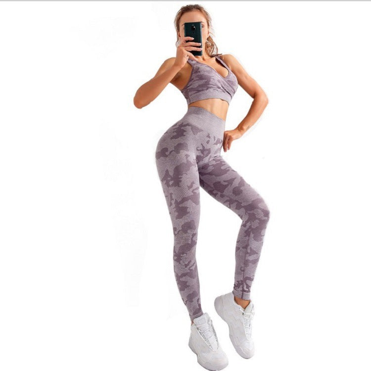 Woman wearing purple camo seamless yoga set with leggings and sports bra, white sneakers, posing for selfie