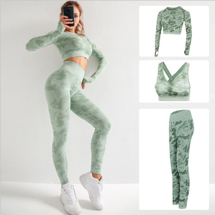 woman wearing green camo 3-piece yoga set including long sleeve crop top, sports bra, and high-waisted leggings