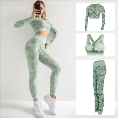 woman wearing green camo 3-piece yoga set including long sleeve crop top, sports bra, and high-waisted leggings