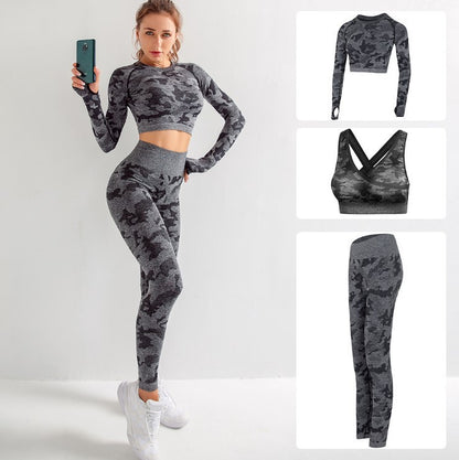 Woman wearing gray and black camo seamless workout set with long sleeve crop top, leggings, and sports bra