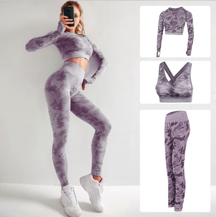 Woman modeling purple camo seamless 3-piece activewear set with leggings, long-sleeve crop top, and sports bra