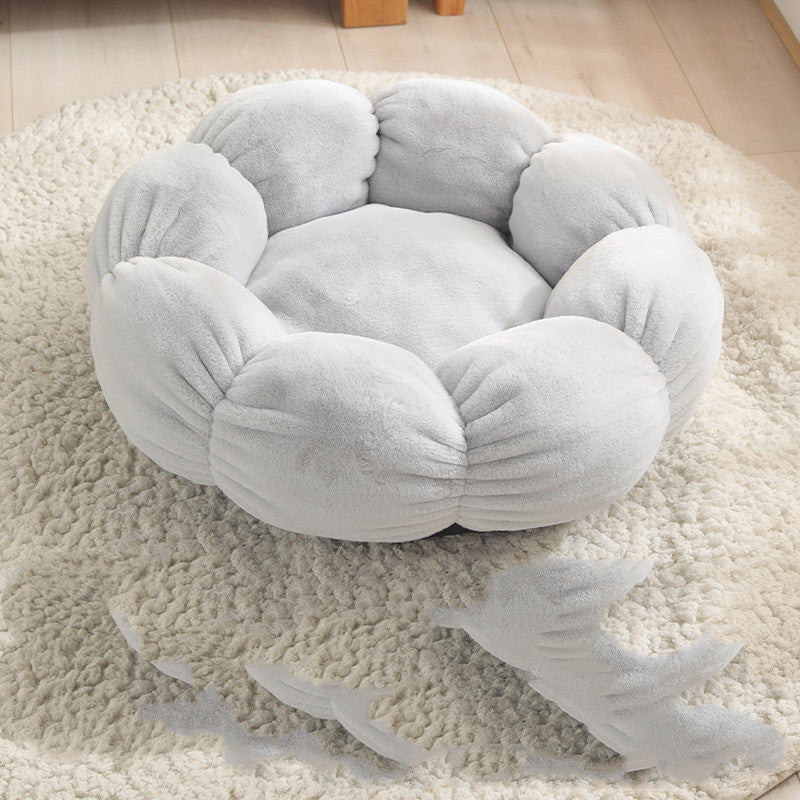 Soft gray flower-shaped plush pet bed on cream textured rug in a cozy room