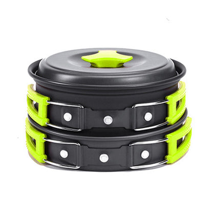 Compact black camping cookware set with green heat-resistant handles and lid knob