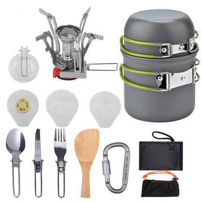 compact green and gray camping cookware set with stove, utensils, folding spoon, fork, knife, wooden spatula, and storage bags