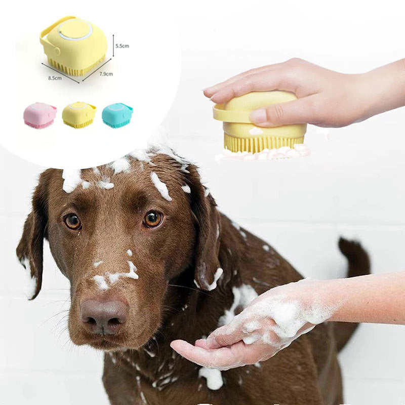 Person using yellow silicone dog bath brush with soft bristles to wash brown dog with shampoo foam