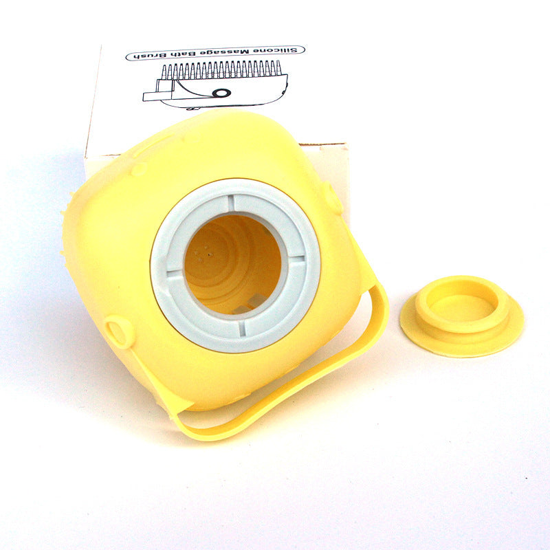 yellow soft silicone pet brush with hollow center and removable cap on white background