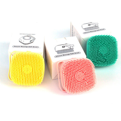 Three silicone massage bath brushes in yellow, pink, and teal with soft bristles and packaging boxes