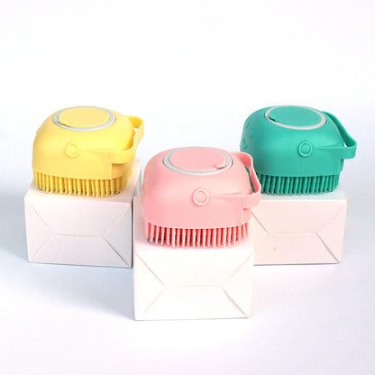 Yellow, pink, and green silicone dog bath brushes with soft bristles on white boxes
