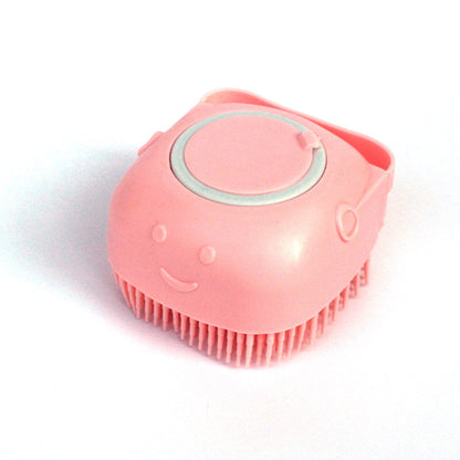 Pink silicone dog bath brush with soft bristles and smiley face grooming tool