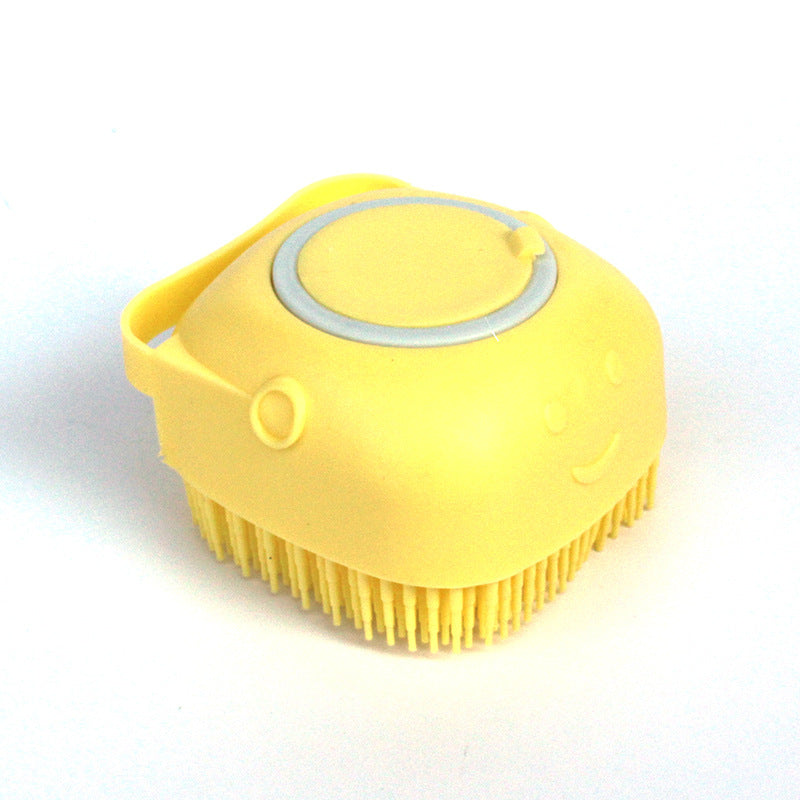 Yellow silicone pet grooming brush with soft bristles and a smiling face design