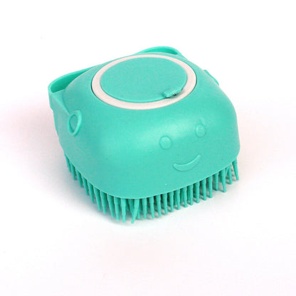 Turquoise silicone dog bath brush with soft bristles and a smiley face design on white background