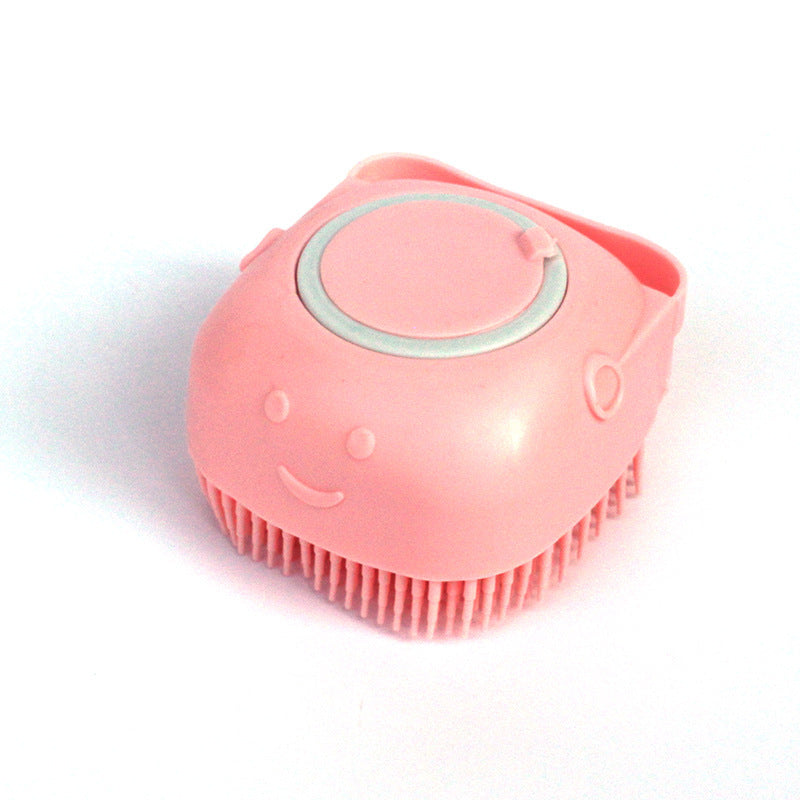 Pink silicone dog bath brush with soft bristles and smiley face design on white background