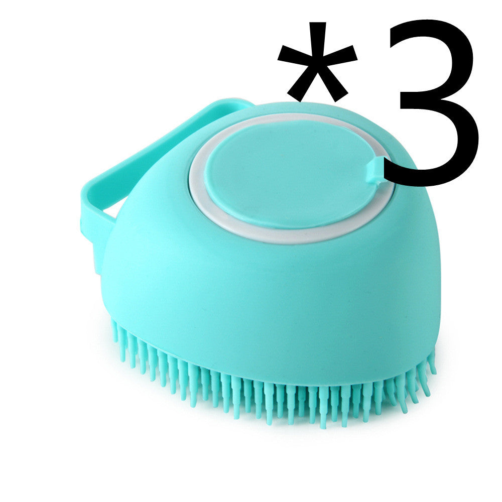 Light blue silicone pet bath brush with soft bristles and handle on white background