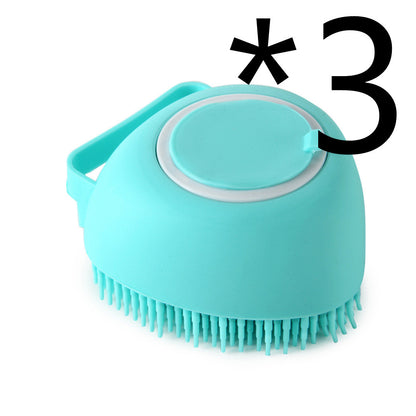 Light blue silicone pet bath brush with soft bristles and handle on white background