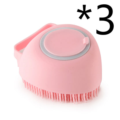 pink silicone pet bath brush with soft bristles and shampoo dispenser on white background