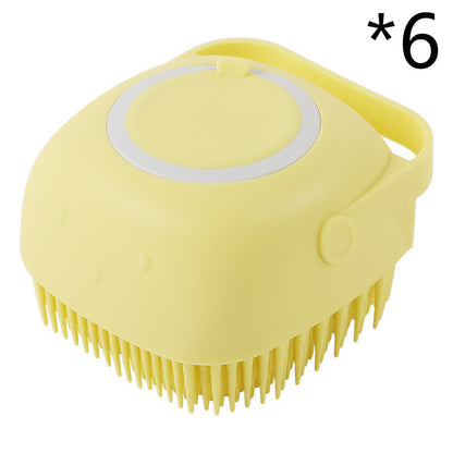 Yellow silicone pet grooming brush with soft bristles and a handle for easy grip