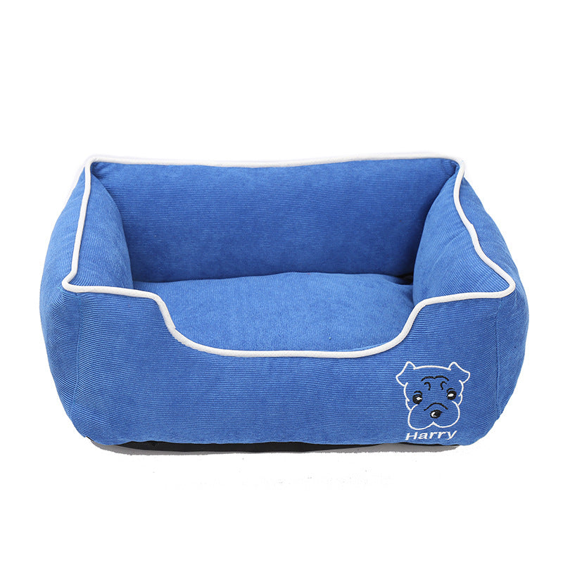 Blue corduroy rectangular dog bed with white trim and dog face embroidery with name Harry