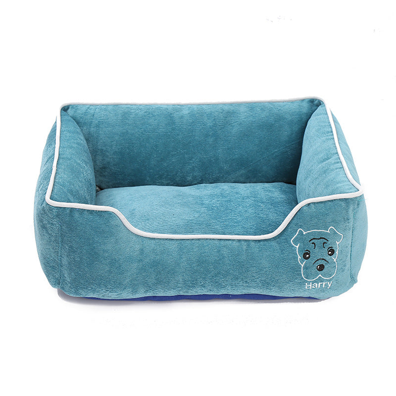 Blue corduroy dog bed with white trim and embroidered dog face design labeled Harry