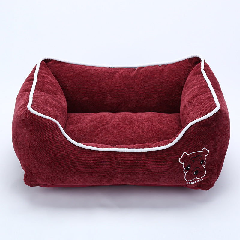 Red corduroy dog bed with white trim and embroidered dog face, soft and cozy pet kennel