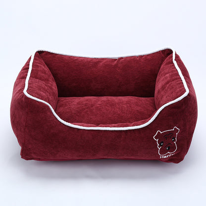 Red corduroy dog bed with white trim and embroidered dog face, soft and cozy pet kennel