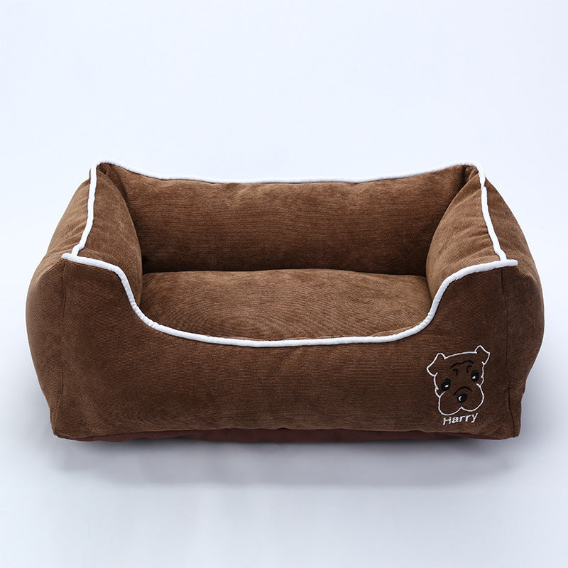 Brown corduroy dog bed with white piping and embroidered dog face labeled Harry