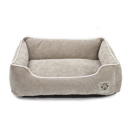 Beige soft corduroy dog bed with raised sides and dog face embroidery on white background